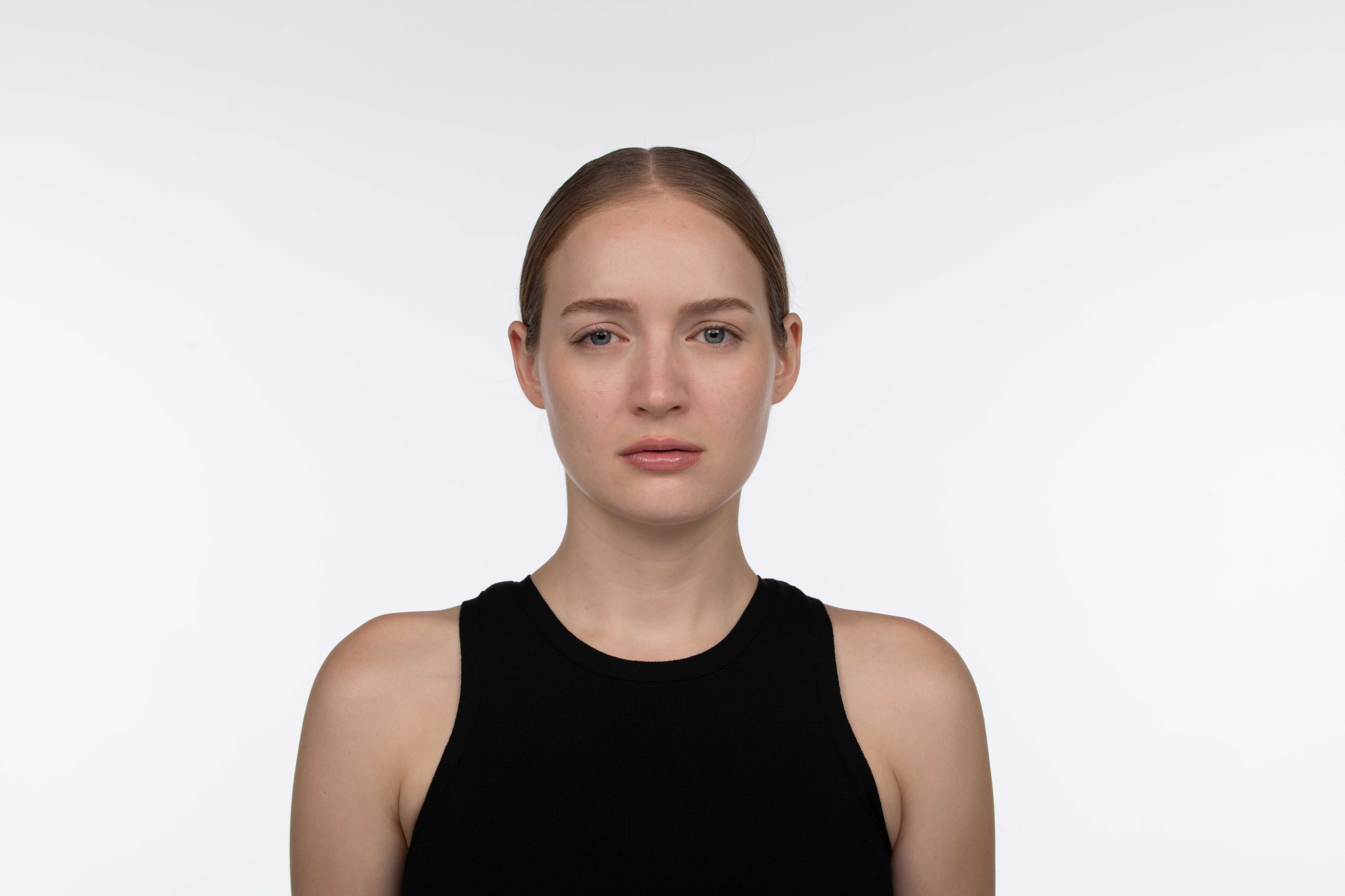 Woman with smooth skin and reduced frown lines 30 days after Jeuveau treatment